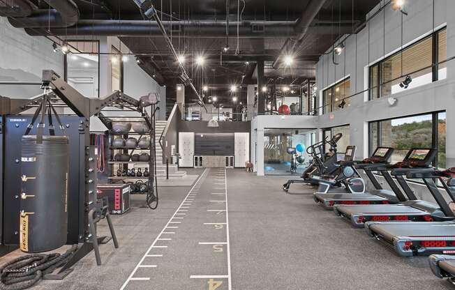 Cardio machines and weights in bi-level fitness studio