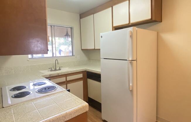 Brittany House 480 Boynton Avenue  San Jose, CA 95117 kitchen view with honey oak cabinets and a white fridge