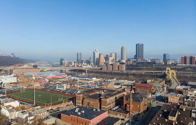 an aerial view of the city with a football field at Residences at South High, Pittsburgh, PA 15203 ? 