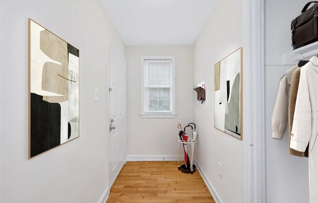 a hallway with a door to a closet and a window