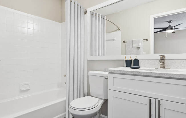 Model Bathroom with White Cabinets, Wood-Style Flooring and Shower/Tub at Element 41 Apartments located in Marietta, GA.