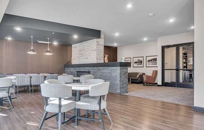 A modern dining room with a fireplace and chairs.