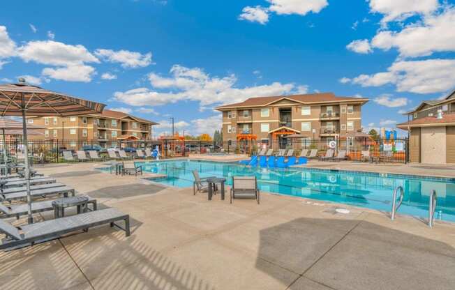 RedPoint Apartments Pool with Lounge Chairs