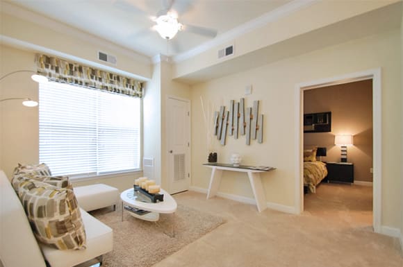 Living room with couch; window; bedroom off living room