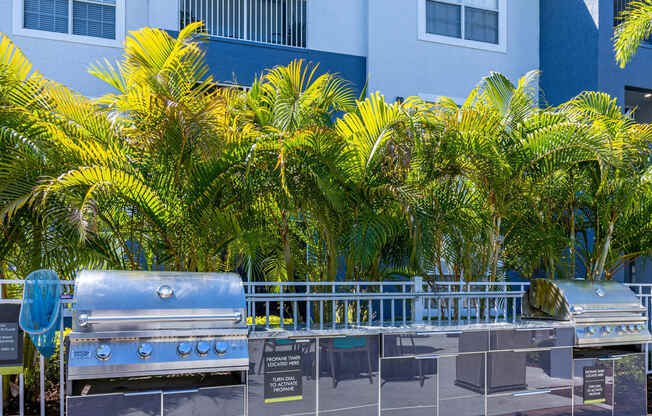 a stainless steel grill in front of a blue building