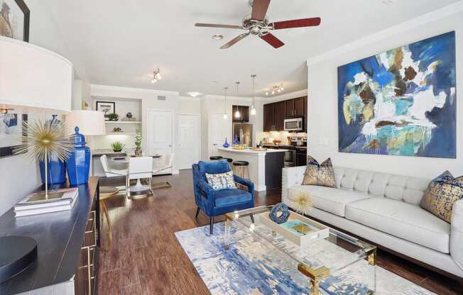 a living room with a white couch and a ceiling fan