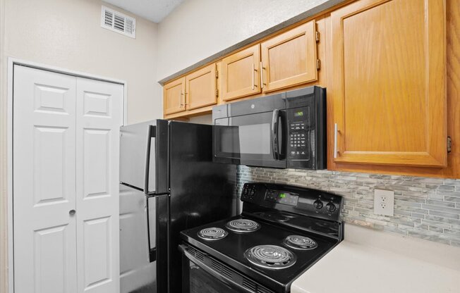 a kitchen with a stove top oven next to a refrigerator