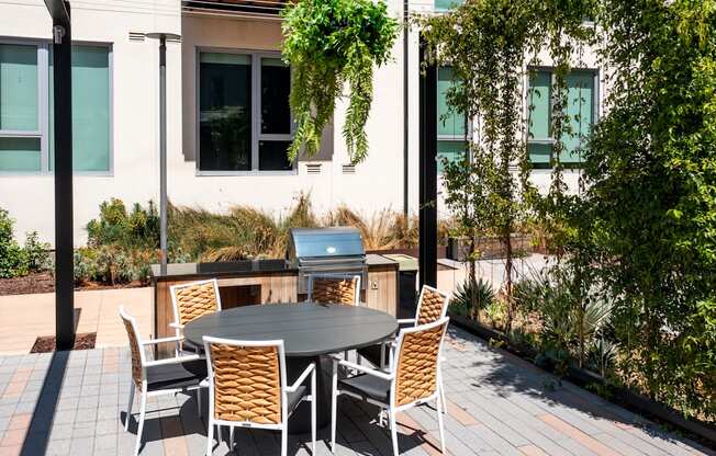 A table with chairs is set up outside on a patio.