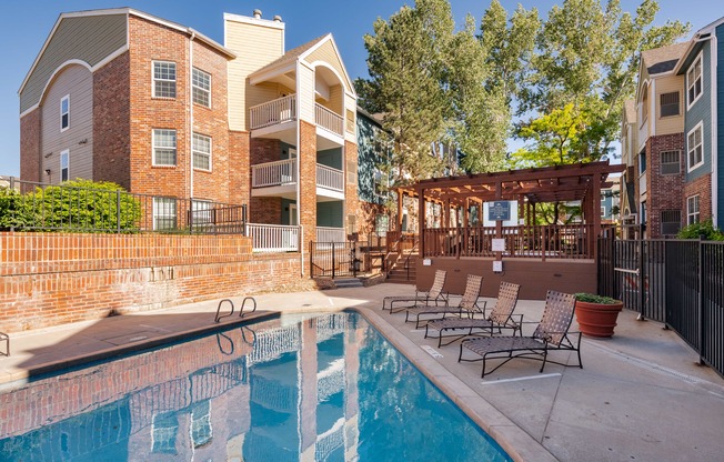 our apartments have a pool and a patio with chairs