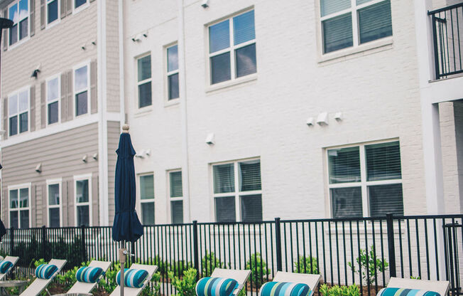 a group of lounge chairs in front of a building