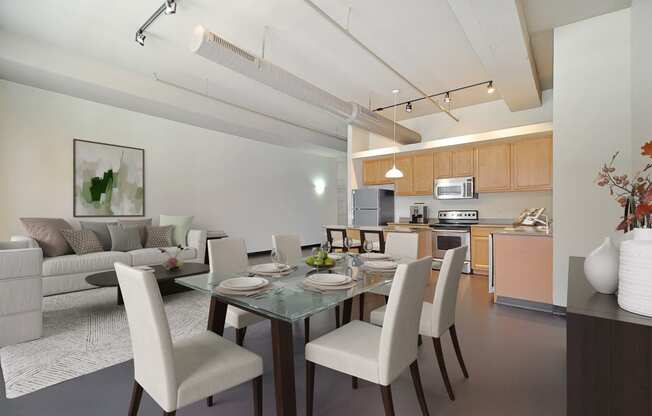 a living room and dining room with a table and chairs