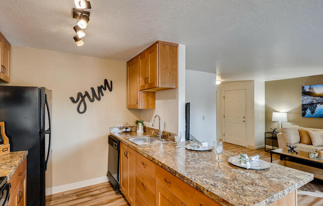 Apartments in Happy Valley, OR - Sunnyside Village Open Concept Kitchen with Granite Countertops and Ample Cabinet Storage