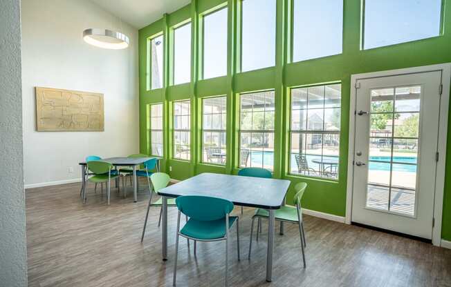 a dining room with a table and chairs and a pool
