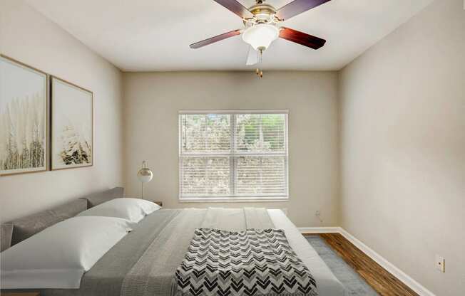 a bedroom with a large bed and a ceiling fan