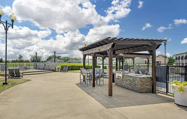 an outdoor patio with tables and chairs and a pergola