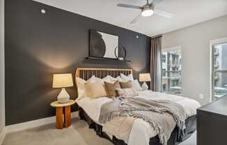 a bedroom with a large bed and a ceiling fan