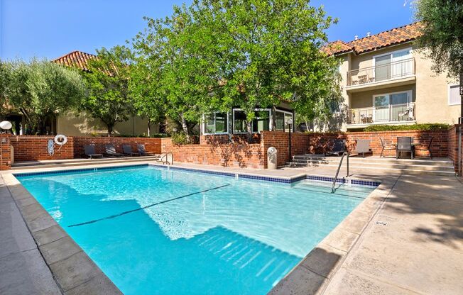 Encino, CA Apartments- Brookside Terrace Apartments- Sparkling Pool with Lounge Chairs and Scenic View of Outdoor Landscaping