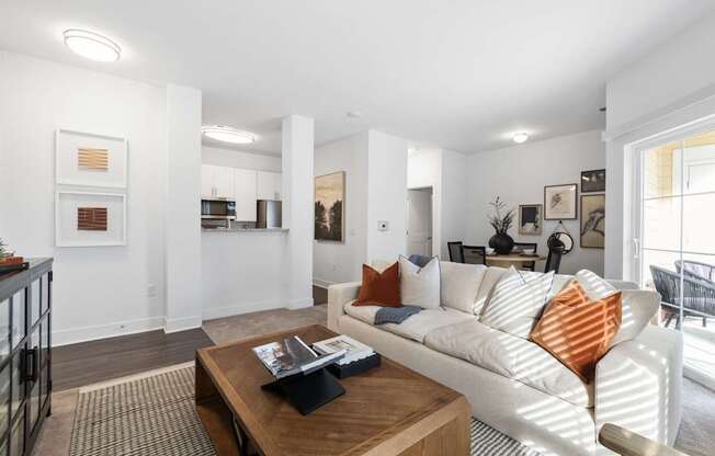 A living room with a white couch and a coffee table.