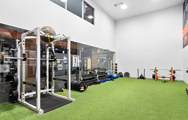 A gym with a green floor and white walls.