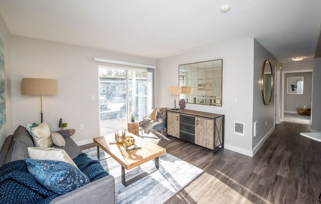 a living room with a gray couch and a wooden coffee table at The Arden Apartments, Gresham