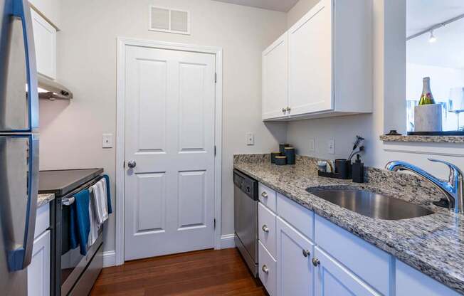 Parkside Commons kitchen with a white cabinetry and a stainless steel refrigerator.