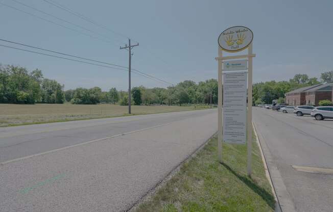 a sign on the side of a road next to a street