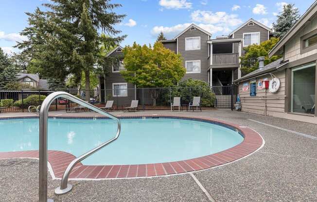 a swimming pool with an apartment building in the background