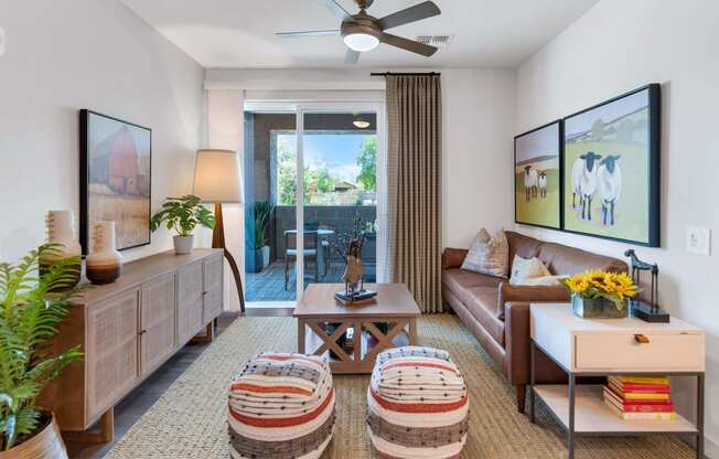 a living room with a couch and a ceiling fanat Weylyn Luxury Apartments, Laveen, AZ
