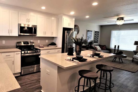 Pet Friendly Apartments in Fremont CA-Pinebrook Apartments Modern Kitchen with Gorgeous Lighting, Matching Stainless Steel Appliances, and Spacious White Cabinets