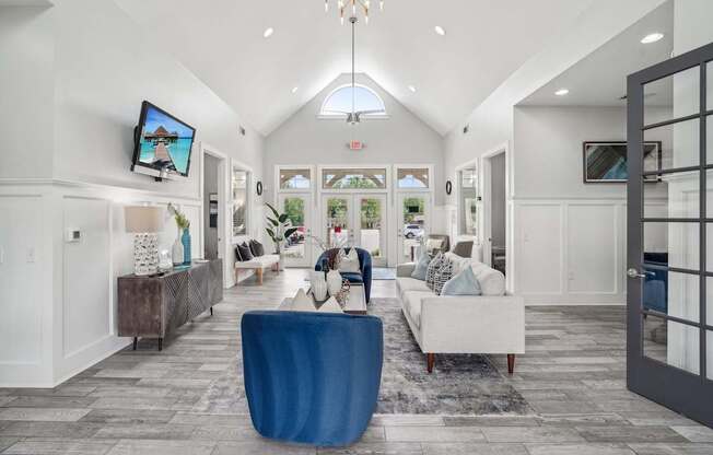 A living room with a blue chair in the middle.