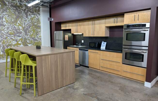 a kitchen with wooden cabinets and a table with yellow chairs