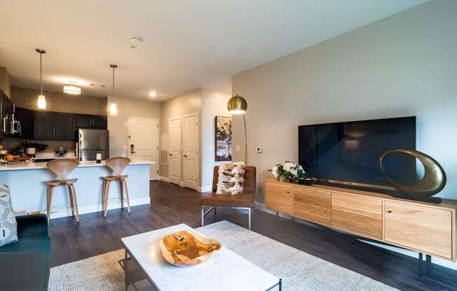 A contemporary living area with a stylish layout, featuring a modern couch, a chic coffee table, and elegant lighting.