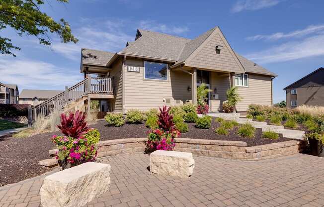 Exterior view of the clubhouse building at Olde English Village, surrounded by well-maintained landscaping and a welcoming atmosphere.