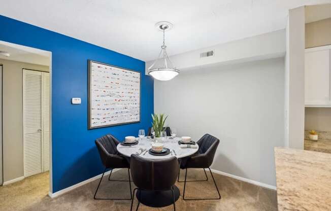 A dining room with a table set for six.