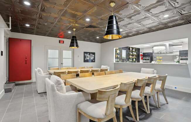 A dining room with a wooden table and chairs.
