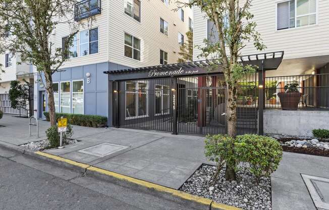 Property Entrance with black and white signage on the front at Promenade at the Park Apartment Homes, Seattle