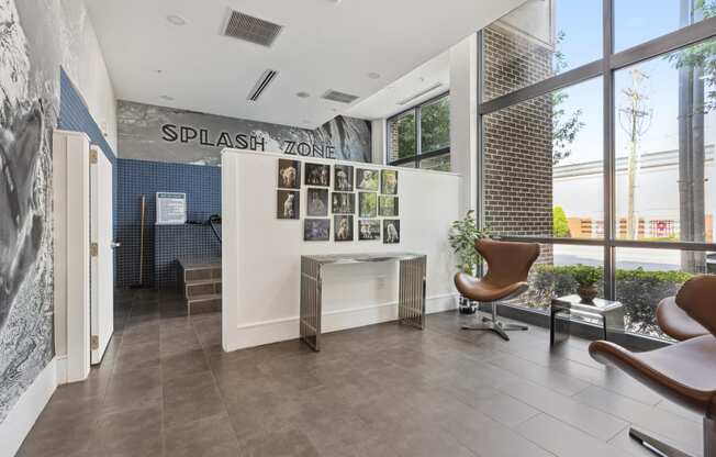 an office with a large window and a desk with a chair