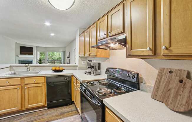 A kitchen with wooden cabinets and a black stove top oven.