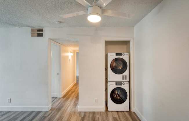 a living room with a washer and dryer