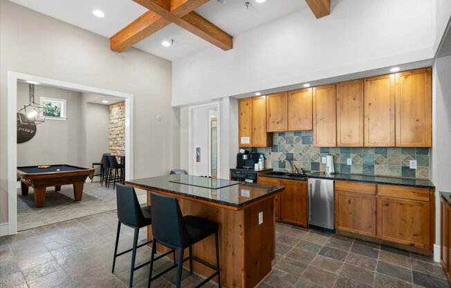 A kitchen with wooden cabinets and a glass island.