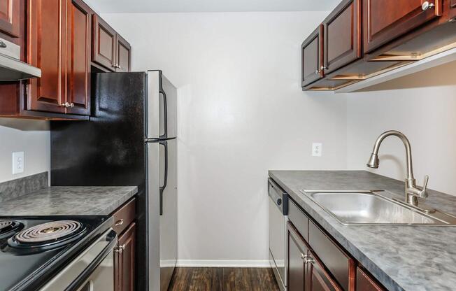 a kitchen with stainless steel appliances and wooden cabinets