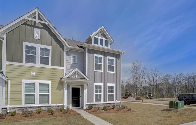 a large house with a blue sky in the background