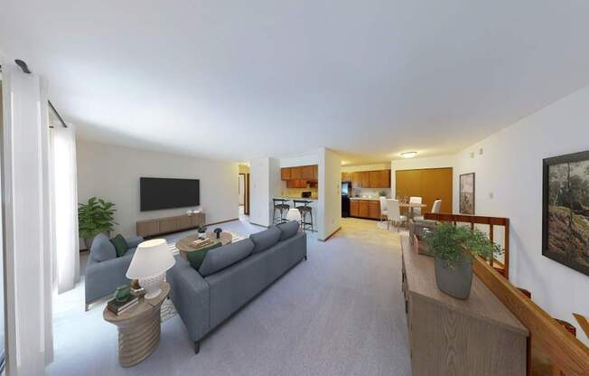A living room with a grey couch and a wooden table.