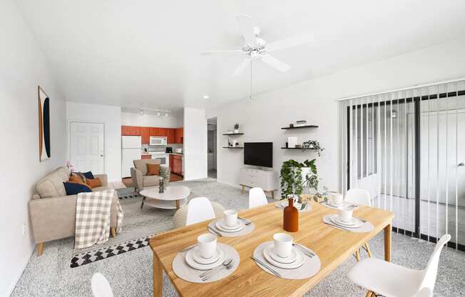 virtually staged dining and living room with carpeted flooring, ceiling fan, and sliding-door patio access