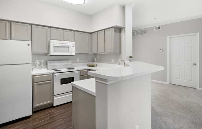 a kitchen with white appliances and a white counter top