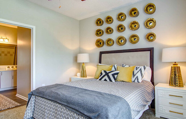 Luxury One, Two and Three Bedroom Apartments in Alpharetta GA - The Ascent at Windward Cozy Bedroom With Lush Carpeting and Gold Themed Decor