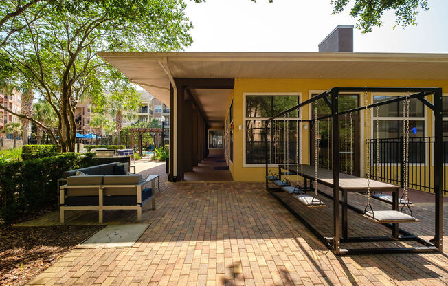 a patio with benches and a building in the background