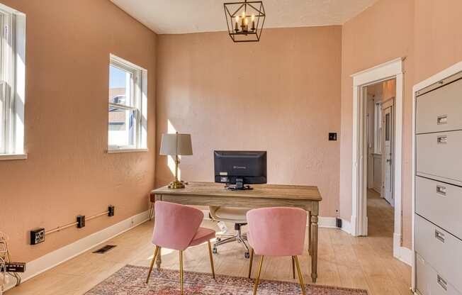 a home office with a desk and two chairs