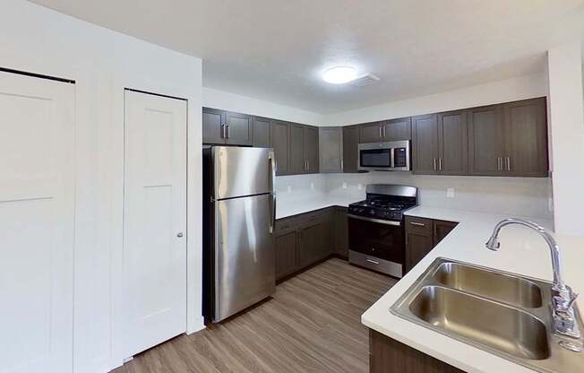 A kitchen with a stainless steel appliances at Meadowbrooke Apartment Homes in Kentwood, MI 49512