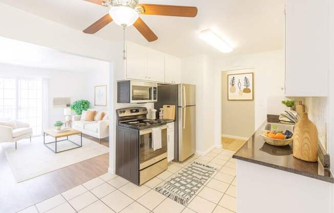 A modern kitchen with a black fridge and stove.